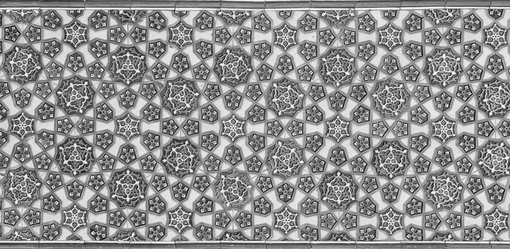 Geometric traditional Islamic ornament. Fragment of a ceramic mosaic. Black and white. photo