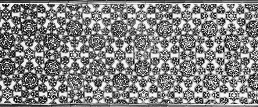 Geometric traditional Islamic ornament. Fragment of a ceramic mosaic. Black and white. photo