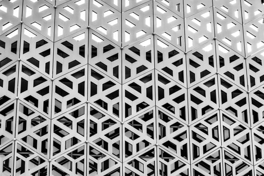 The texture of the cladding of a building made of metal aluminum panels with a carved pattern. Abstract background. Black and white. photo