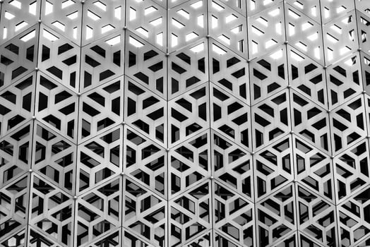 The texture of the cladding of a building made of metal aluminum panels with a carved pattern. Abstract background. Black and white. photo