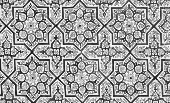 Black and white geometric traditional Islamic ornament on a tile. Fragment of a ceramic mosaic.Abstract background. photo