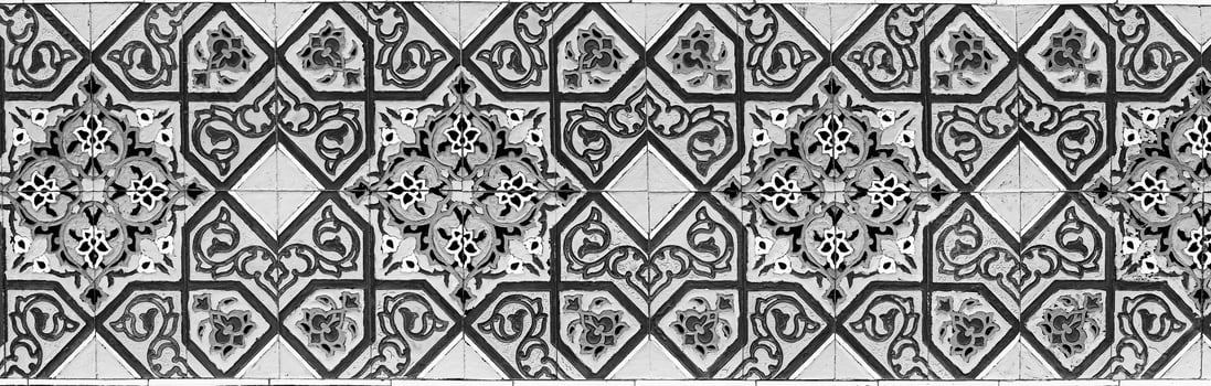 Black and white geometric traditional Islamic ornament on a tile. Fragment of a ceramic mosaic.Abstract background. photo