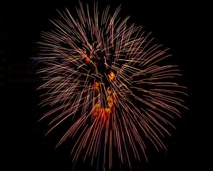 Colorful celebration fireworks isolated on a black sky background. photo