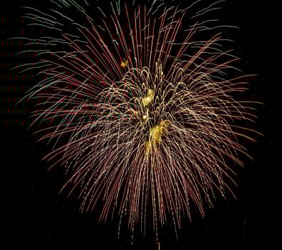 Colorful celebration fireworks isolated on a black sky background. photo