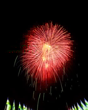Colorful celebration fireworks isolated on a black sky background and waving flags of Uzbekistan. photo