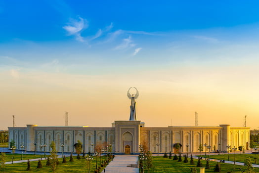 UZBEKISTAN, TASHKENT - APRIL 25, 2023 The territory of the park New Uzbekistan with Monument of Independence in the form of a stele with a Humo bird at twilight. photo
