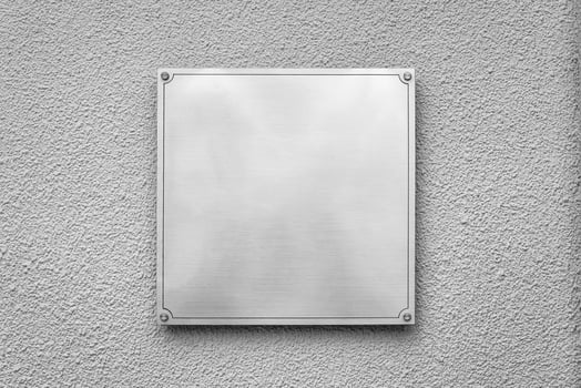 Steel square board with copyspace for text hanging on the wall. Mockup for design. photo