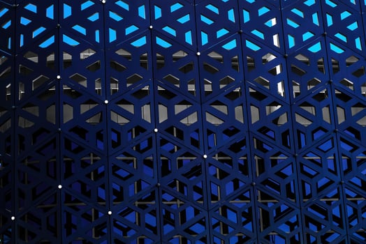 The texture of the cladding of a building made of metal aluminum panels with a carved pattern. Abstract background. photo