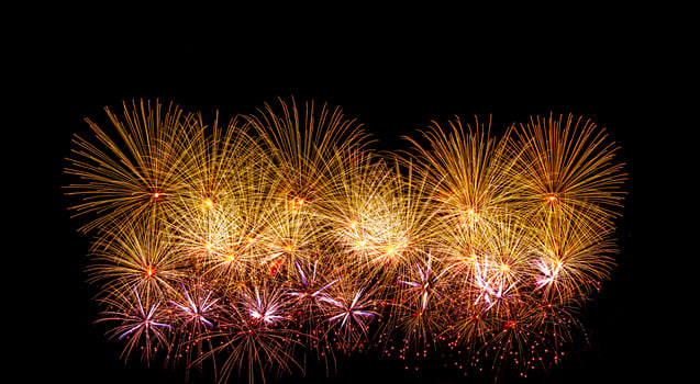 Colorful celebration fireworks isolated on a black sky background. photo