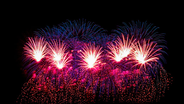 Colorful celebration fireworks isolated on a black sky background. photo