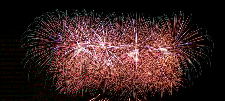 Colorful celebration fireworks isolated on a black sky background. photo