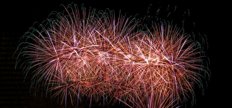 Colorful celebration fireworks isolated on a black sky background. photo