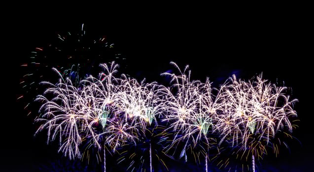 Colorful celebration fireworks isolated on a black sky background. photo