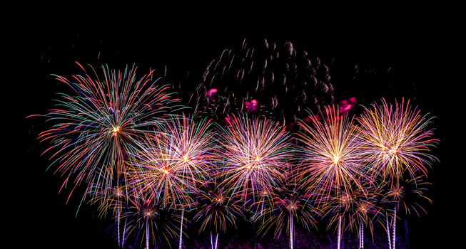 Colorful celebration fireworks isolated on a black sky background. photo