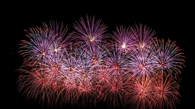 Colorful celebration fireworks isolated on a black sky background. photo