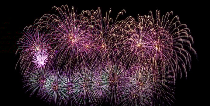 Colorful celebration fireworks isolated on a black sky background. photo
