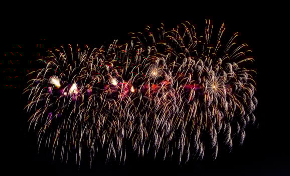 Colorful celebration fireworks isolated on a black sky background. photo