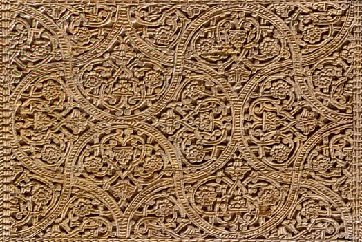 Fragment of an ancient carved wooden door. Ornate. photo