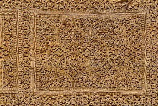 Fragment of an ancient carved wooden door. Ornate. photo