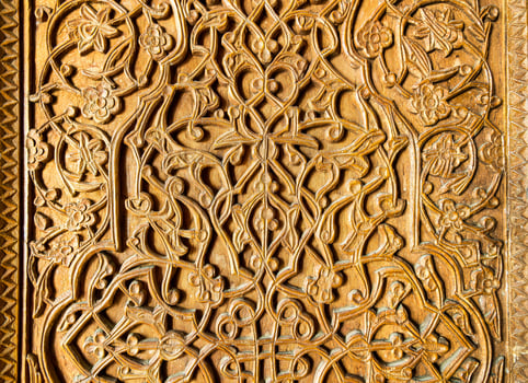 Fragment of an ancient carved wooden door. Ornate. photo