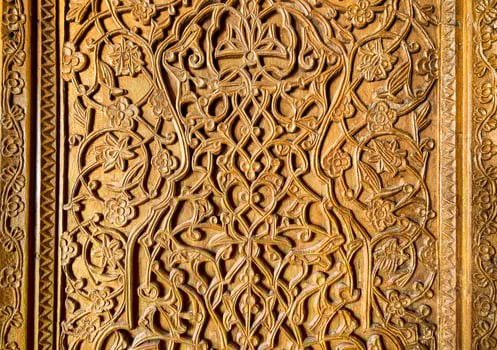 Fragment of an ancient carved wooden door. Ornate. photo