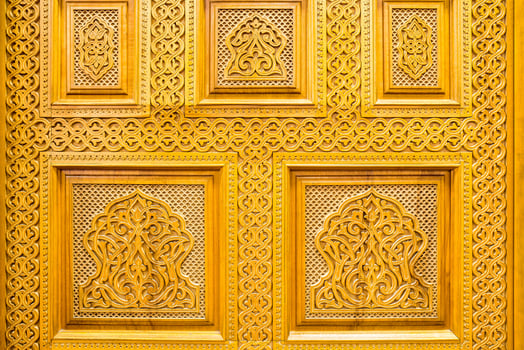 Carved wooden doors with patterns and mosaics. Abstract background. photo