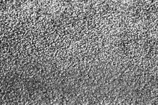 Monochrome texture of shiny grained metal. Abstract background. photo