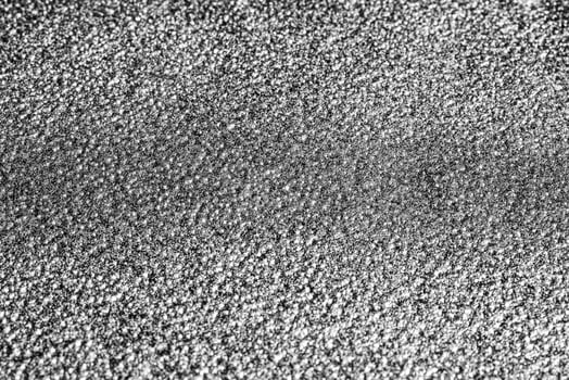 Monochrome texture of shiny grained metal. Abstract background. photo