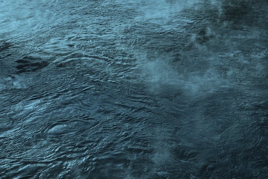The texture of the waves of blue color of fast-flowing water in the river. photo