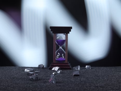 An Hourglass with Vibrant Purple Sand Measuring Time Elegantly photo