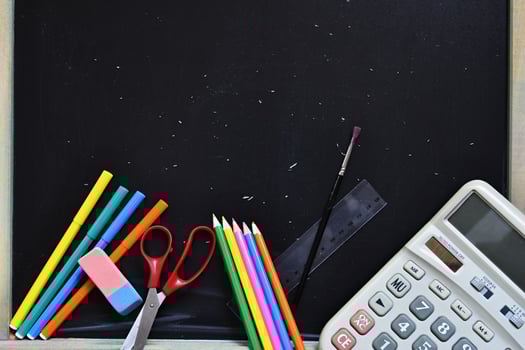 Background back to school. Blackboard with school aids. photo