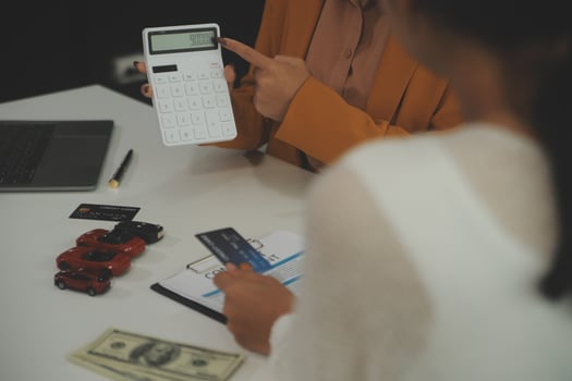 auto business, sale and people concept - close up of customer giving credit card to car dealer in auto show or salon photo