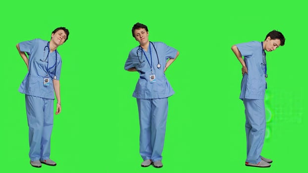 Health specialist suffering from lower back pain after working after hours, feeling in pain and overworked with night shifts. Nurse having spine discomfort from scoliosis and bad posture. Camera A. photo