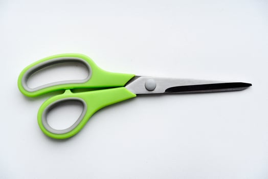 Sewing scissors on a white background. Green scissors. photo