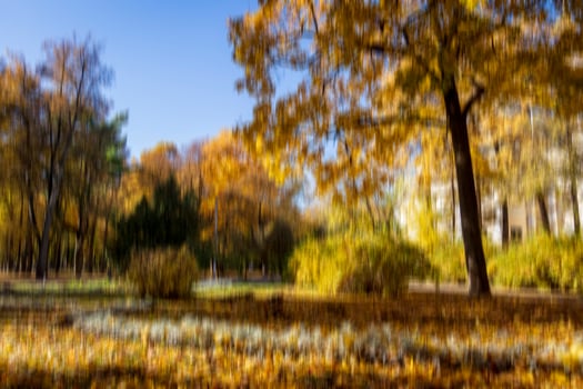 Autumn park vertical motion blurr background. Fall season abstract. photo