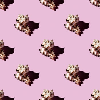 Seamless pattern of clam shells on a pastel pink background. photo