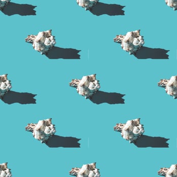 Seamless pattern of clam shells on a cyan background. photo