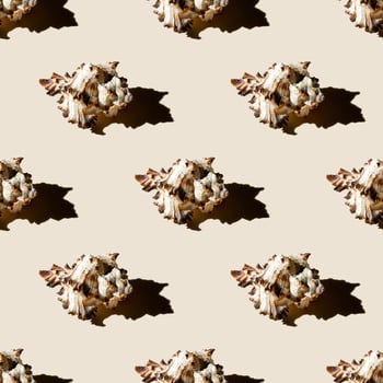 Seamless pattern of clam shells on a pastel yellow background. photo