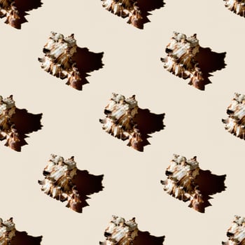 Seamless pattern of clam shells on a pastel yellow background. photo