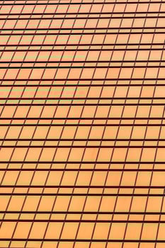 Fragment of a modern office building. Abstract geometric background. Part of a skyscraper with glass windows. photo