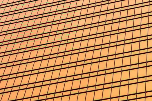 Fragment of a modern office building. Abstract geometric background. Part of a skyscraper with glass windows. photo