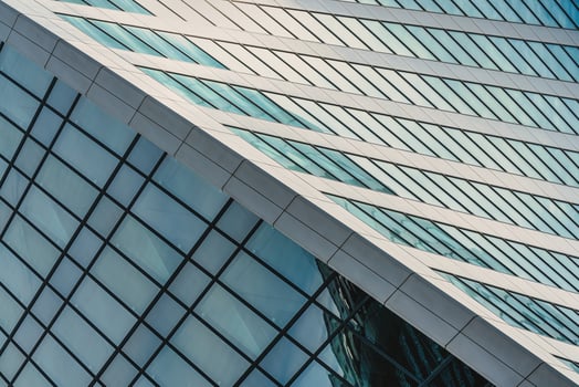 Fragment of a modern office building. Abstract geometric background. Part of a skyscraper with glass windows. photo