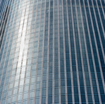 Fragment of a modern office building. Abstract geometric background. Part of a skyscraper with glass windows. photo