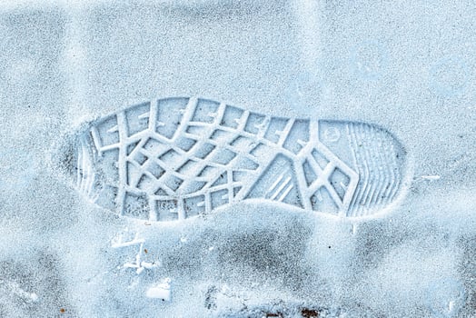 Boot track on thin first snow in winter. photo