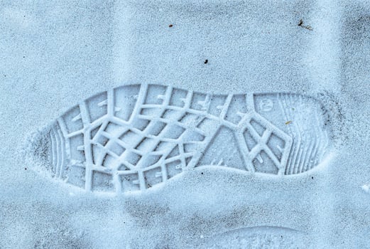 Boot track on thin first snow in winter. photo