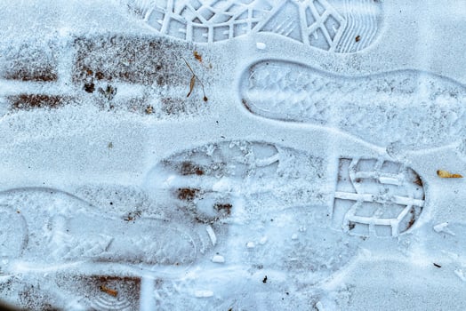 Boot track on thin first snow in winter. photo