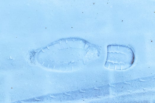Boot track on thin first snow in winter. photo