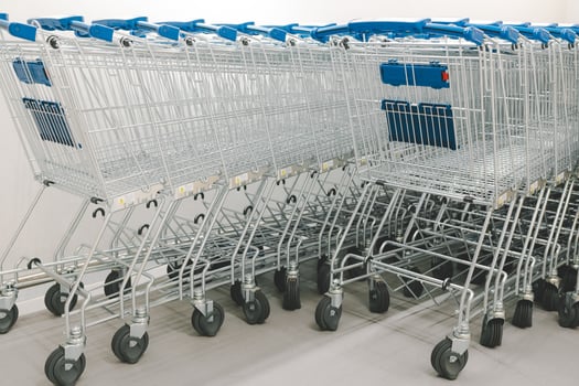Rows of shopping carts on car park near entrance. row of empty shopping carts in the supermarket. photo