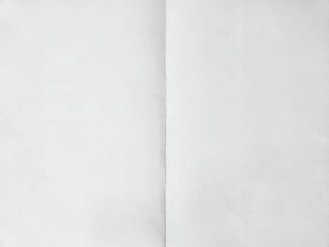 Blank paper folded on two. Background photo