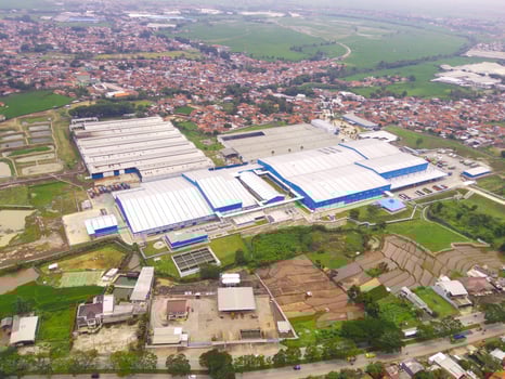 Snack Factory on the outskirts of town. Aerial view of factory in mountain valley, Bandung - Indonesia. Food Industry. Above. Aerial Landscapes. Shot from a drone. photo